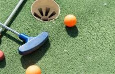 photo of mini golf putters and balls